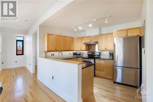 Kitchen features granite counters, stainless steel appliances, undermounted lighting - 364 Cooper Street Unit#403, Ottawa, ON - Indoor Photo Showing Kitchen