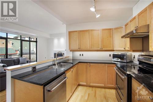 Kitchen features granite counters, stainless steel appliances, undermounted lighting - 364 Cooper Street Unit#403, Ottawa, ON - Indoor Photo Showing Kitchen With Stainless Steel Kitchen With Double Sink