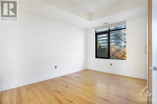 2nd bedroom with 2 armoire closets and hardwood floors - 364 Cooper Street Unit#403, Ottawa, ON - Indoor Photo Showing Other Room