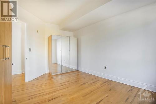 2nd bedroom with 2 armoire closets and hardwood floors - 364 Cooper Street Unit#403, Ottawa, ON - Indoor Photo Showing Other Room