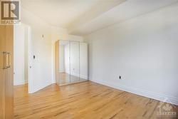 2nd bedroom with 2 armoire closets and hardwood floors - 