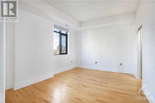 Primary bedroom with hardwood floors - 364 Cooper Street Unit#403, Ottawa, ON - Indoor Photo Showing Other Room