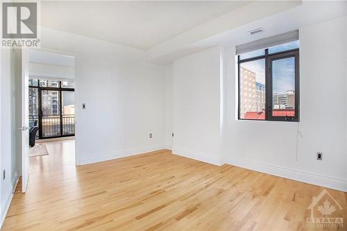 Primary bedroom with hardwood floors - 364 Cooper Street Unit#403, Ottawa, ON - Indoor Photo Showing Other Room