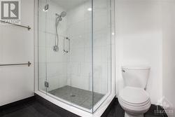 Primary ensuite bathroom has been recenlty renovated and features double vanity sink, glassed in shower and tile flooring - 