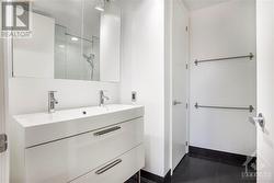 Primary ensuite bathroom has been recenlty renovated and features double vanity sink, glassed in shower and tile flooring - 