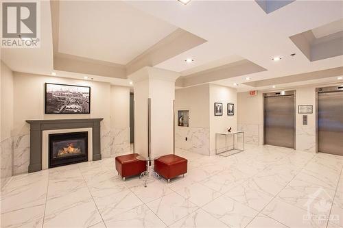 Front lobby - 364 Cooper Street Unit#403, Ottawa, ON - Indoor Photo Showing Other Room With Fireplace