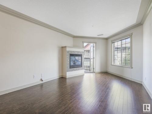 #303 16235 51 St Nw Nw, Edmonton, AB - Indoor Photo Showing Living Room With Fireplace