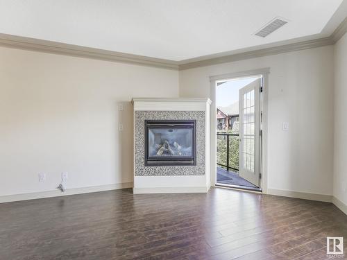 #303 16235 51 St Nw Nw, Edmonton, AB - Indoor Photo Showing Living Room With Fireplace