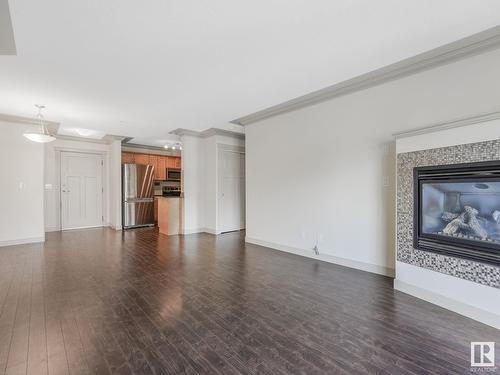 #303 16235 51 St Nw Nw, Edmonton, AB - Indoor Photo Showing Living Room With Fireplace