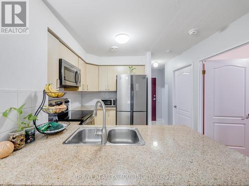 Builtin Micrwave - 309 - 7405 Goreway Drive, Mississauga (Malton), ON - Indoor Photo Showing Kitchen With Double Sink