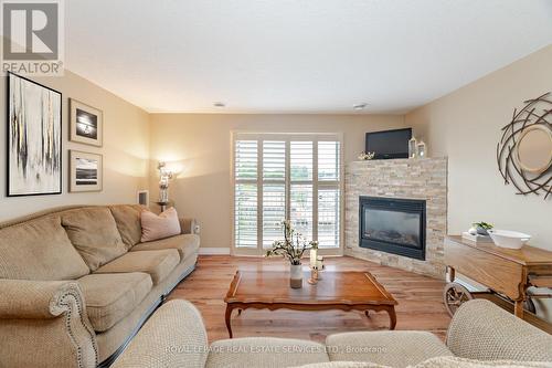 406 - 12 St Andrew Street, Norfolk, ON - Indoor Photo Showing Living Room With Fireplace