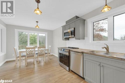 Kitchen with a wealth of natural light, appliances with stainless steel finishes, and decorative light fixtures - 530 Addington Road 5, Cloyne, ON - Indoor