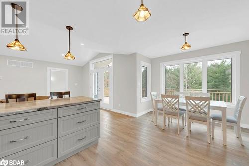 Kitchen with pendant lighting, plenty of natural light, light hardwood / wood-style floors, and vaulted ceiling - 530 Addington Road 5, Cloyne, ON - Indoor Photo Showing Dining Room