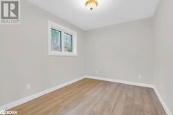 Empty room with light wood-type flooring - 