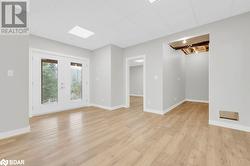 Spare room with light wood-type flooring and french doors - 