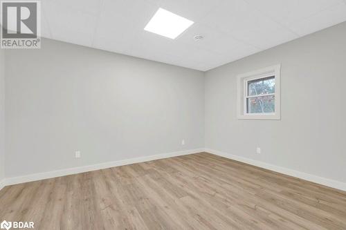 Empty room featuring a drop ceiling and light hardwood / wood-style floors - 530 Addington Road 5, Cloyne, ON - Indoor Photo Showing Other Room