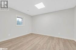 Spare room with light hardwood / wood-style floors and a paneled ceiling - 