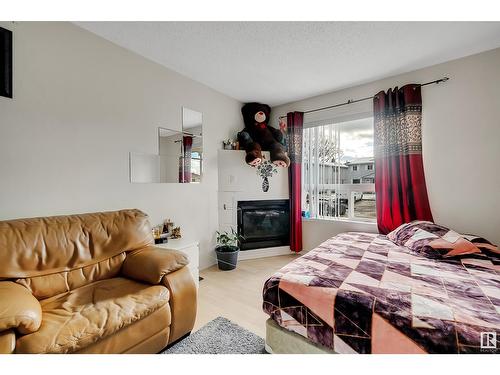 #20 1580 Mill Woods E Nw, Edmonton, AB - Indoor Photo Showing Bedroom With Fireplace