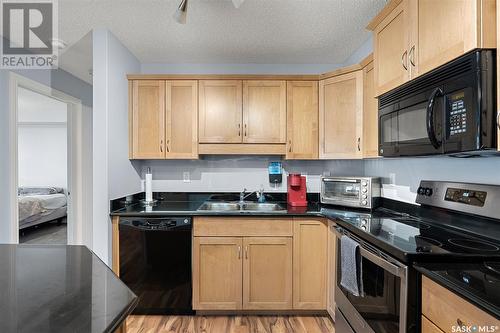 B210 103 Wellman Crescent, Saskatoon, SK - Indoor Photo Showing Kitchen With Double Sink