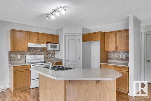 103 Rue Masson, Beaumont, AB - Indoor Photo Showing Kitchen With Double Sink