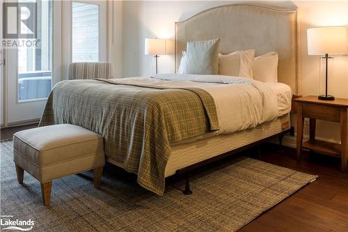 Bedroom featuring wood flooring - 1869 Muskoka Road 118 W Unit# L204-D2, Muskoka Lakes, ON - Indoor Photo Showing Bedroom