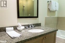 Bathroom with tiled shower / bath and vanity - 