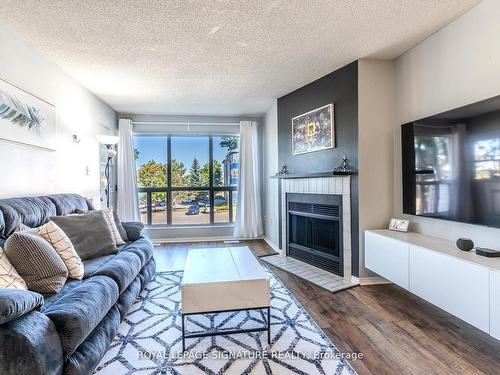 215-126 Bell Farm Rd, Barrie, ON - Indoor Photo Showing Living Room With Fireplace