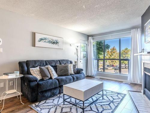 215-126 Bell Farm Rd, Barrie, ON - Indoor Photo Showing Living Room With Fireplace