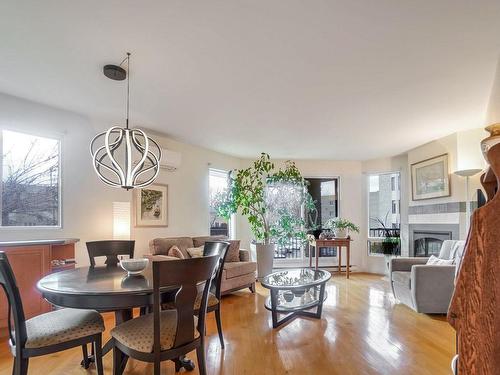 Overall view - 205-5240 Rue Riviera, Montréal (Pierrefonds-Roxboro), QC - Indoor Photo Showing Dining Room With Fireplace