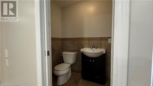 Bathroom featuring toilet, vanity, tile walls, and tile patterned floors - 406 Erb Street W Unit# 2, Waterloo, ON - Indoor Photo Showing Bathroom