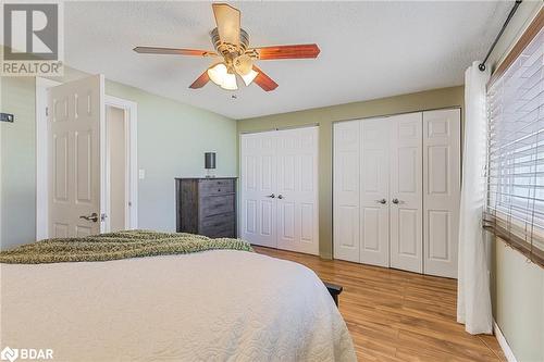 Bedroom featuring multiple closets, light wood-type flooring, a textured ceiling, and ceiling fan - 325 William Williams Street Unit# 31, Shelburne, ON - Indoor Photo Showing Bedroom