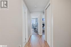 Hall with light hardwood / wood-style floors - 