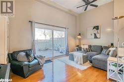 Living room featuring hardwood / wood-style floors and ceiling fan - 