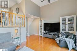 Living room featuring hardwood / wood-style floors, ceiling fan, and high vaulted ceiling - 