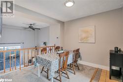 Dining room with ceiling fan, a textured ceiling, and light tile patterned floors - 