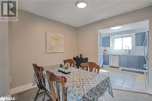 Tiled dining area featuring a textured ceiling and sink - 325 William Williams Street Unit# 31, Shelburne, ON - Indoor Photo Showing Dining Room