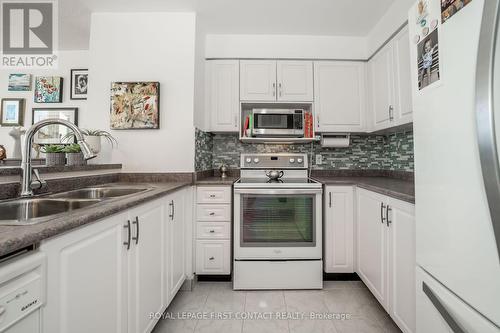 711 - 150 Dunlop Street E, Barrie, ON - Indoor Photo Showing Kitchen With Double Sink