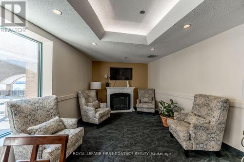 711 - 150 Dunlop Street E, Barrie, ON - Indoor Photo Showing Living Room With Fireplace