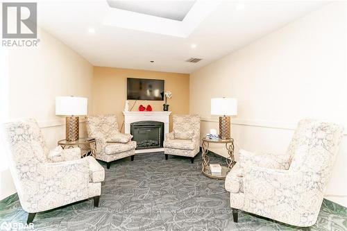 711 - 150 Dunlop Street E, Barrie, ON - Indoor Photo Showing Living Room With Fireplace