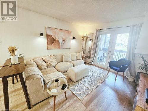 Living room featuring hardwood / wood-style flooring and french doors - 2030 Cleaver Avenue Unit# 122, Burlington, ON - Indoor Photo Showing Living Room