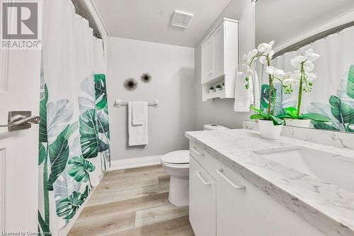 Bathroom featuring toilet, vanity, and hardwood / wood-style flooring - 2030 Cleaver Avenue Unit# 122, Burlington, ON - Indoor Photo Showing Bathroom