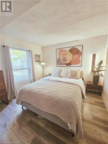 Bedroom with a textured ceiling and hardwood / wood-style flooring - 2030 Cleaver Avenue Unit# 122, Burlington, ON - Indoor Photo Showing Bedroom