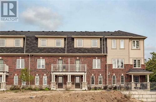 View of front of home with a balcony - 88 Decorso Drive Unit# 44, Guelph, ON - Outdoor With Balcony With Facade