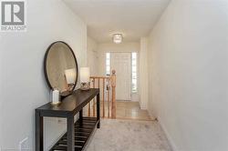 Doorway to outside featuring a textured ceiling and light carpet - 