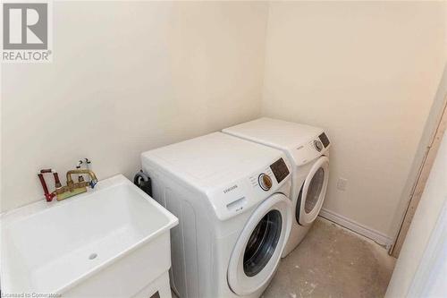 Clothes washing area with separate washer and dryer and sink - 88 Decorso Drive Unit# 44, Guelph, ON - Indoor Photo Showing Laundry Room