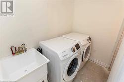 Clothes washing area with separate washer and dryer and sink - 