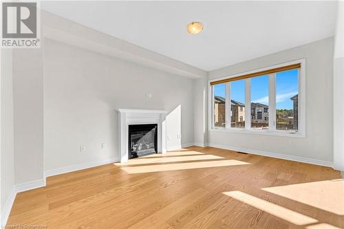 Unfurnished living room with light hardwood / wood-style flooring - 1174 Upper Thames Drive, Woodstock, ON - Indoor Photo Showing Living Room With Fireplace