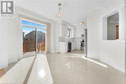 Unfurnished living room with light tile patterned floors and ornate columns - 