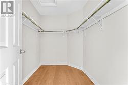 Spacious closet featuring hardwood / wood-style floors - 