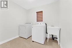 Laundry room with sink and independent washer and dryer - 